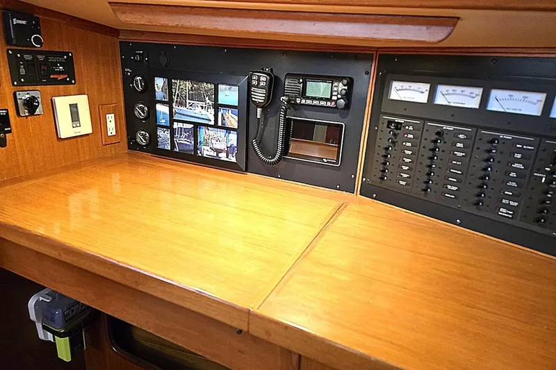 Slide: The Image of Navigation station of 1992 Taswell 43 All Season yacht with control panels and communication equipment. - 11