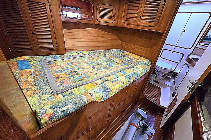 Slide: The Image of Cozy cabin interior of 1992 Taswell 43 All Season yacht with colorful bedding. - 14