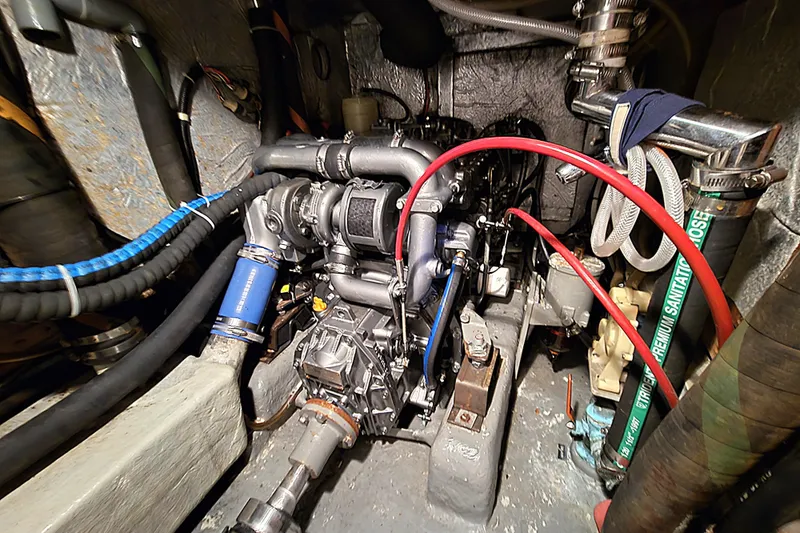 Slide: The Image of Engine room of 1992 Taswell 43 All Season yacht, showcasing complex machinery and hoses. - 21