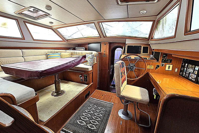 Slide: The Image of Interior of 1992 Taswell 43 All Season yacht with seating, table, and navigation area. - 5