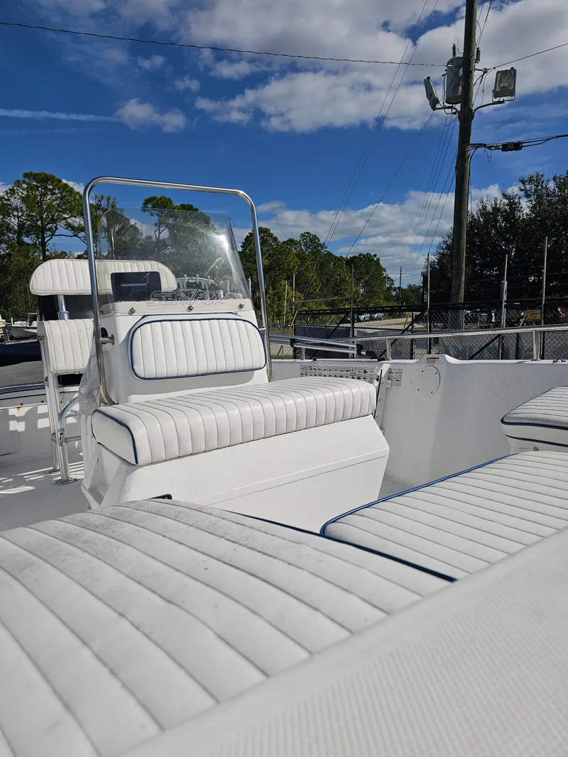 Slide: The Image of 2006 Sea Fox 195 Bay Fisher with white upholstery under blue sky. - 19