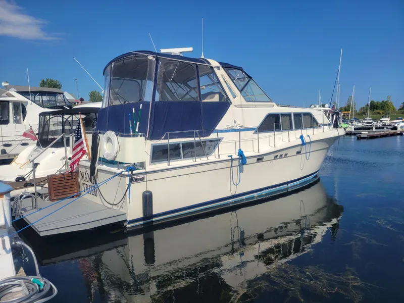 The Image of 1986 Chris-Craft 381 Catalina yacht docked at marina under clear blue sky. - 0
