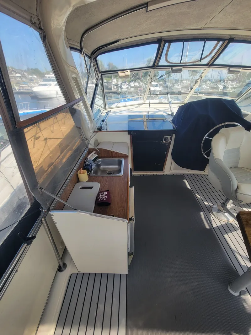 Slide: The Image of 1986 Chris-Craft 381 Catalina interior with helm, sink, and seating area. - 12