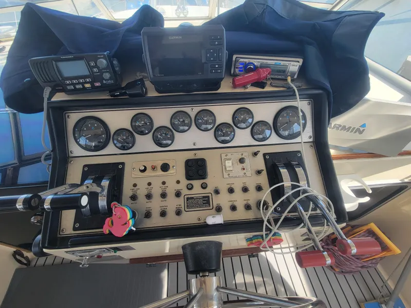 Slide: The Image of 1986 Chris-Craft 381 Catalina boat dashboard with gauges and navigation equipment. - 13