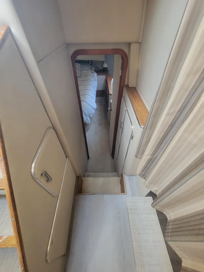Slide: The Image of 1986 Chris-Craft 381 Catalina interior with narrow passageway and visible bedroom. - 17