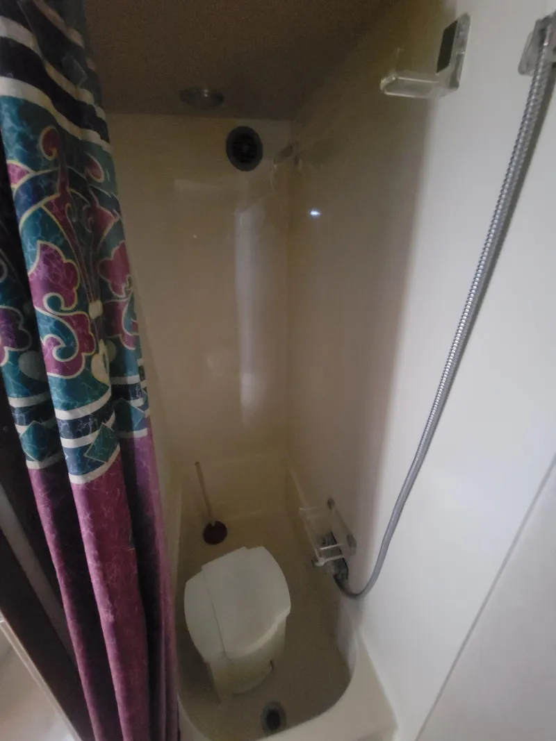 Slide: The Image of Shower area in 1986 Chris-Craft 381 Catalina boat with colorful curtain. - 22