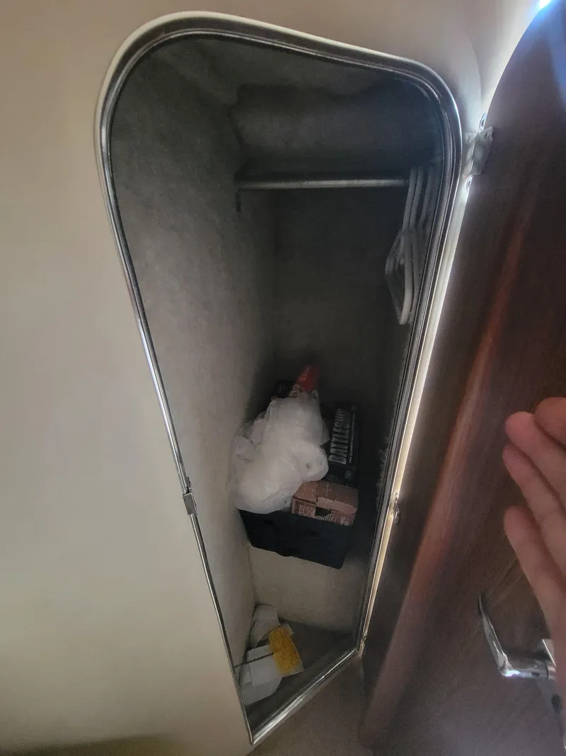 Slide: The Image of 1986 Chris-Craft 381 Catalina closet interior with storage items. - 23