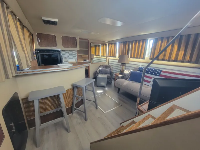 Slide: The Image of Interior of 1986 Chris-Craft 381 Catalina yacht with cozy seating and kitchen area. - 24