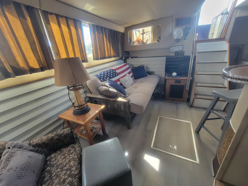 Slide: The Image of Interior of 1986 Chris-Craft 381 Catalina yacht with cozy seating and decor. - 28