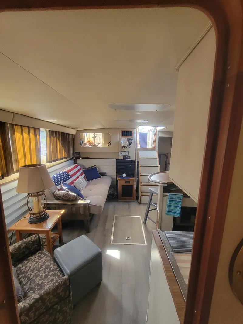 Slide: The Image of Interior of 1986 Chris-Craft 381 Catalina yacht with cozy seating and nautical decor. - 31