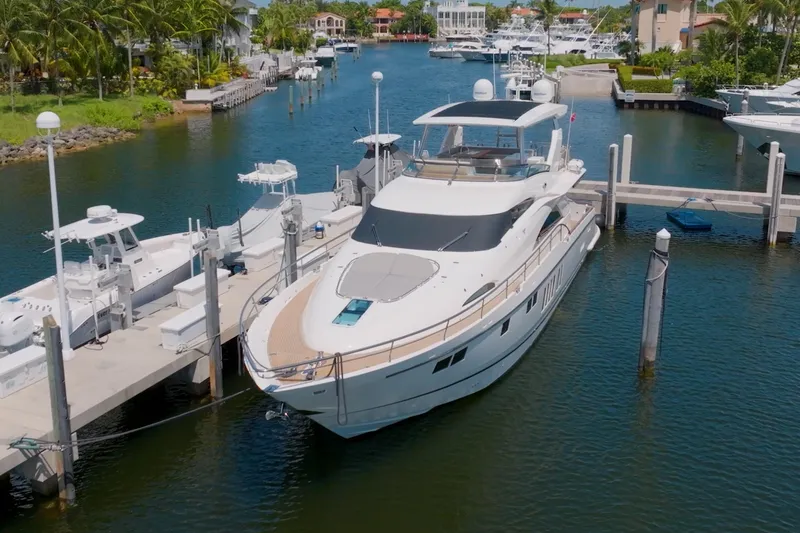 Slide: The Image of Luxury 2014 Fairline Squadron 78 Custom yacht docked in a scenic marina. - 2