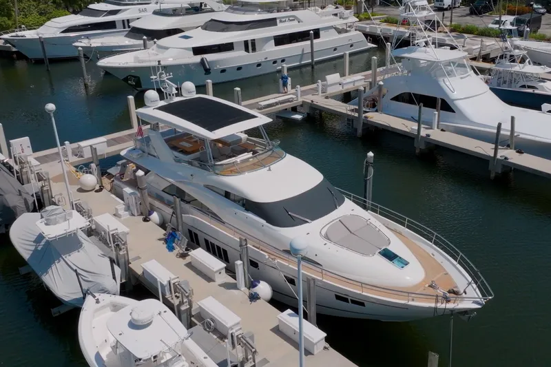 Slide: The Image of 2014 Fairline Squadron 78 Custom yacht docked at marina, surrounded by other luxury boats. - 22