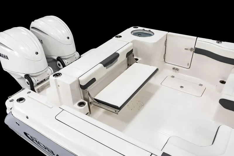 Slide: The Image of 2026 Robalo R277 Dual Console boat interior with Yamaha engines, featuring seating and storage compartments. - 17