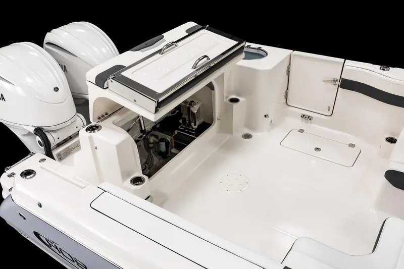Slide: The Image of 2026 Robalo R277 Dual Console boat interior with dual engines and storage compartments. - 18