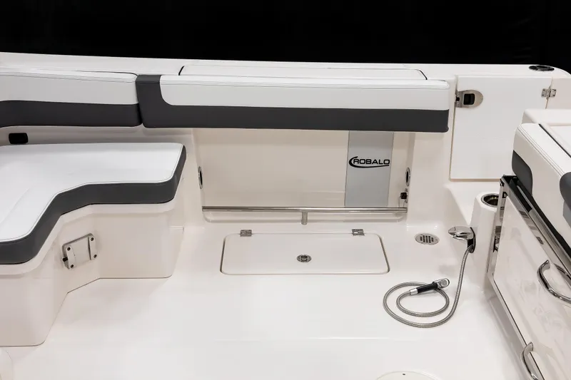 Slide: The Image of 2026 Robalo R277 Dual Console boat interior with seating and storage compartments. - 19