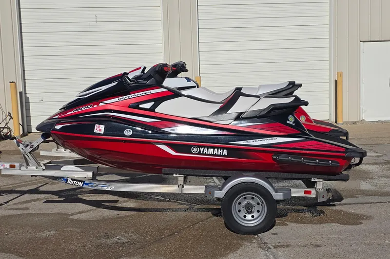Slide: The Image of 2019 Yamaha WaveRunner GP1800R SVHO on trailer, red and black design, parked outdoors. - 3