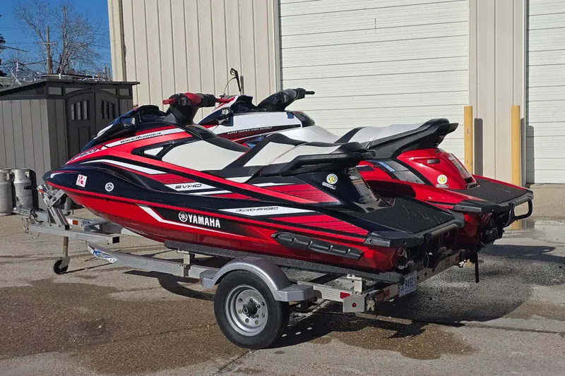 Slide: The Image of 2019 Yamaha WaveRunner GP1800R SVHO jet skis on a trailer, parked outdoors. - 4