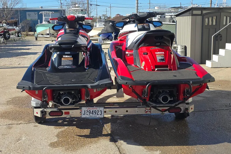 Slide: The Image of Two 2019 Yamaha WaveRunner GP1800R SVHO jet skis on a trailer, parked outdoors. - 5