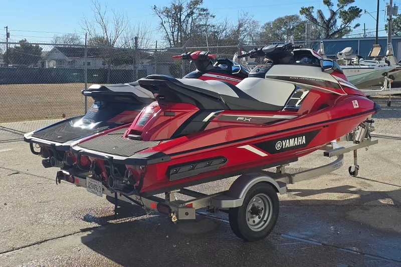 Slide: The Image of 2019 Yamaha WaveRunner GP1800R SVHO jet skis on a trailer, parked outdoors. - 6