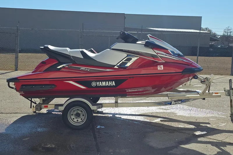Slide: The Image of 2019 Yamaha WaveRunner GP1800R SVHO on trailer, red and black design, parked outdoors. - 7