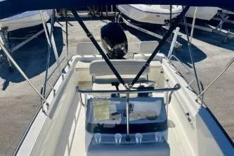 Slide: The Image of 2023 Boston Whaler 170 Montauk boat interior with canopy and seating. - 10