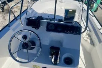 Slide: The Image of 2023 Boston Whaler 170 Montauk boat console with steering wheel and controls. - 11
