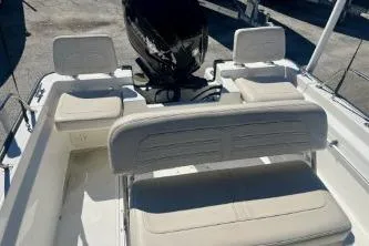 Slide: The Image of 2023 Boston Whaler 170 Montauk boat interior with seating and motor. - 12