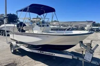 Slide: The Image of 2023 Boston Whaler 170 Montauk boat on trailer, featuring a blue canopy. - 3