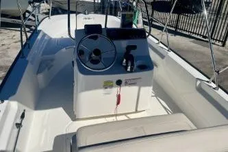 Slide: The Image of 2023 Boston Whaler 170 Montauk boat interior with steering console and seating. - 7