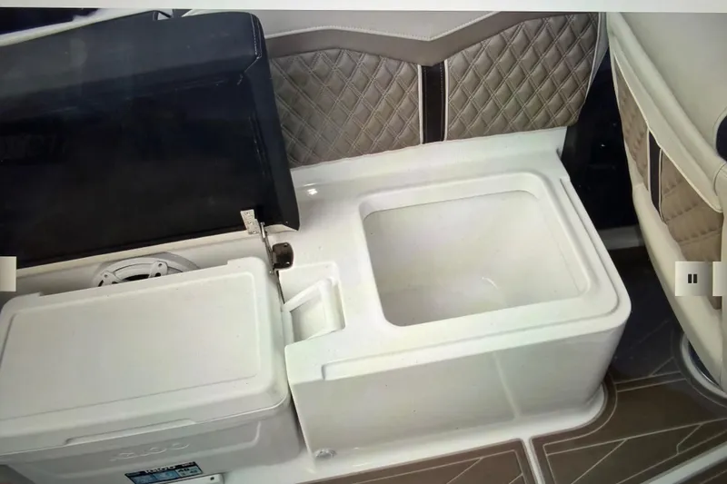 Slide: The Image of 2024 Monterey 255SS Super Sport boat interior with storage compartment and cooler. - 29