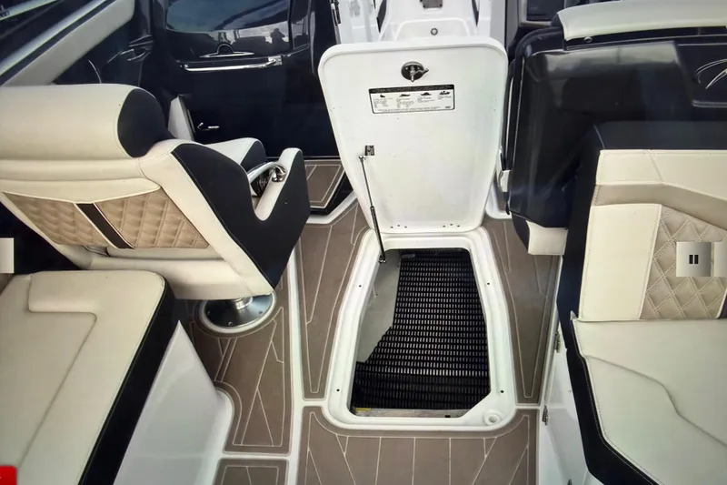 Slide: The Image of 2024 Monterey 255SS Super Sport interior with open storage compartment and luxurious seating. - 33