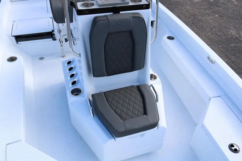 Slide: The Image of 2026 Xpress H20B Bay boat interior with cushioned seating and rod holders. - 10