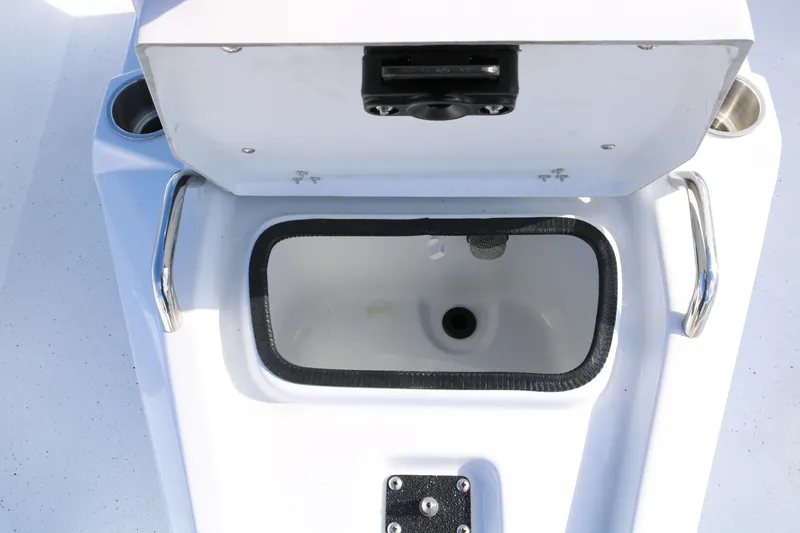 Slide: The Image of Open storage compartment on 2026 Xpress H20B Bay boat, featuring stainless steel handles. - 13