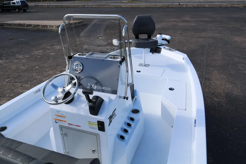 Slide: The Image of 2026 Xpress H20B Bay boat interior with steering console and seating. - 2