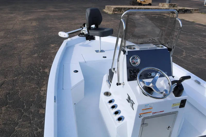 Slide: The Image of 2026 Xpress H20B Bay boat interior with steering console and seating. - 23