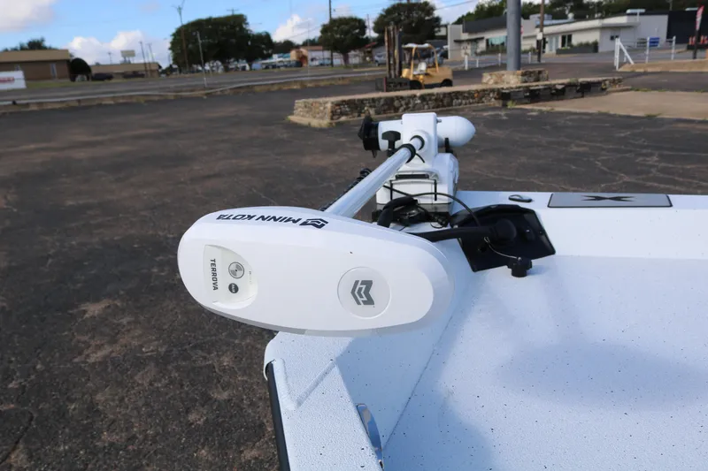 Slide: The Image of 2026 Xpress H20B Bay boat with Minn Kota Terrova trolling motor in a parking lot. - 24