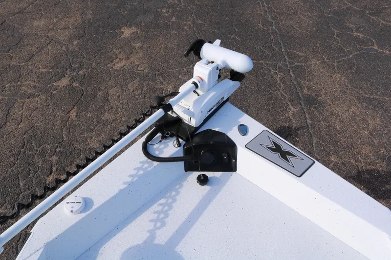 Slide: The Image of 2026 Xpress H20B Bay boat with Minn Kota trolling motor on textured surface. - 4