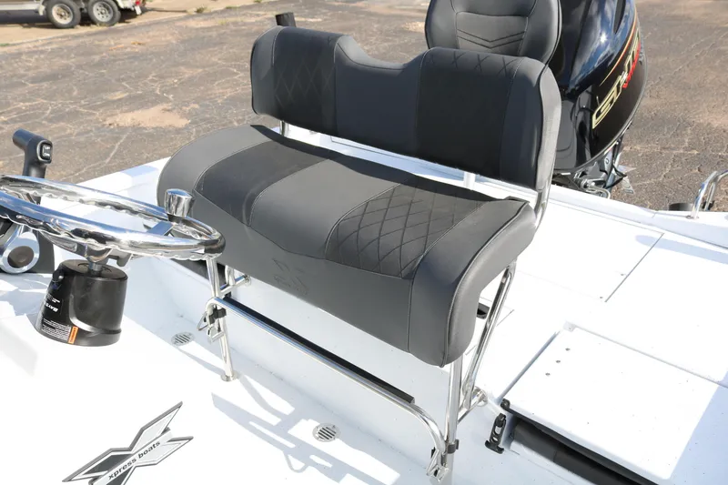 Slide: The Image of 2026 Xpress H20B Bay boat interior with steering wheel and cushioned seating. - 43