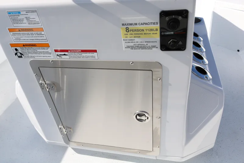 Slide: The Image of 2026 Xpress H20B Bay boat console with capacity and warning labels. - 46