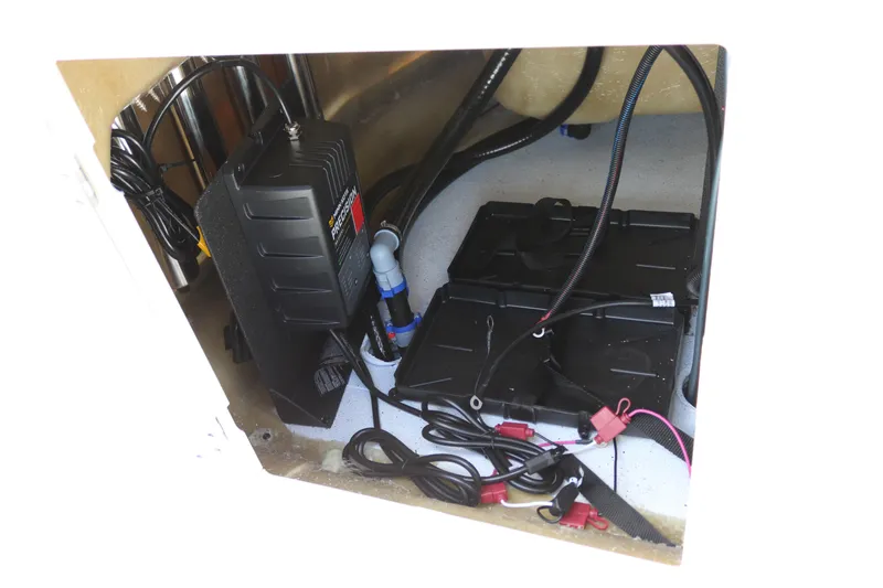Slide: The Image of 2026 Xpress H20B Bay boat battery compartment with wiring and charger. - 47
