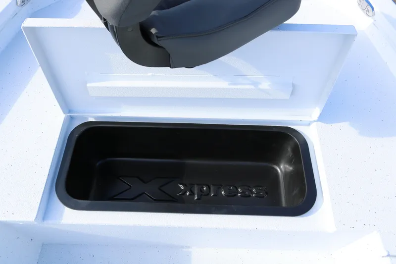 Slide: The Image of 2026 Xpress H20B Bay boat storage compartment with logo, open lid, and seat. - 9