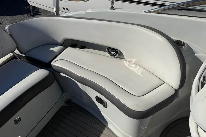 Slide: The Image of 2019 Crownline Eclipse E255 XS boat interior seating with cup holders and speaker. - 11