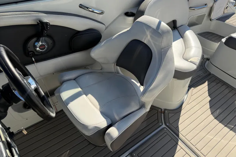 Slide: The Image of Captain's seat and helm of 2019 Crownline Eclipse E255 XS boat. - 18
