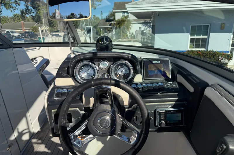 Slide: The Image of 2019 Crownline Eclipse E255 XS boat dashboard with steering wheel and navigation controls. - 19