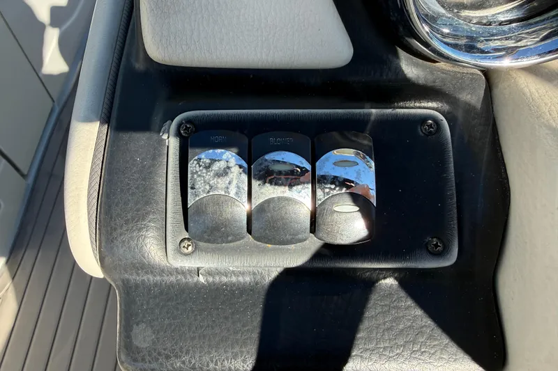 Slide: The Image of Control panel of a 2019 Crownline Eclipse E255 XS boat with switches. - 25