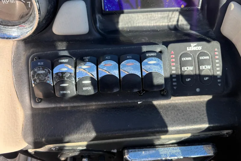 Slide: The Image of Control panel of a 2019 Crownline Eclipse E255 XS boat with various switches and indicators. - 26