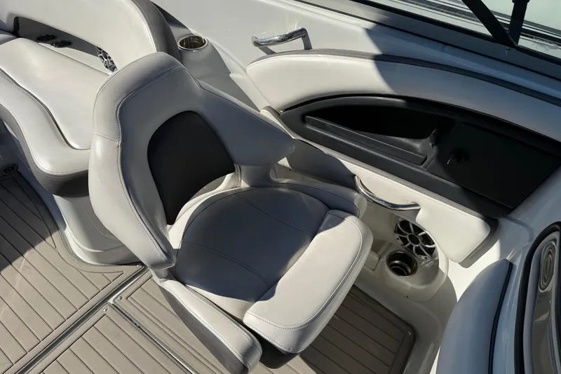 Slide: The Image of 2019 Crownline Eclipse E255 XS boat interior with gray seating and cup holders. - 29