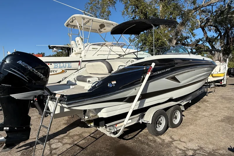 Slide: The Image of 2019 Crownline Eclipse E255 XS boat on trailer with Mercury outboard motor. - 3