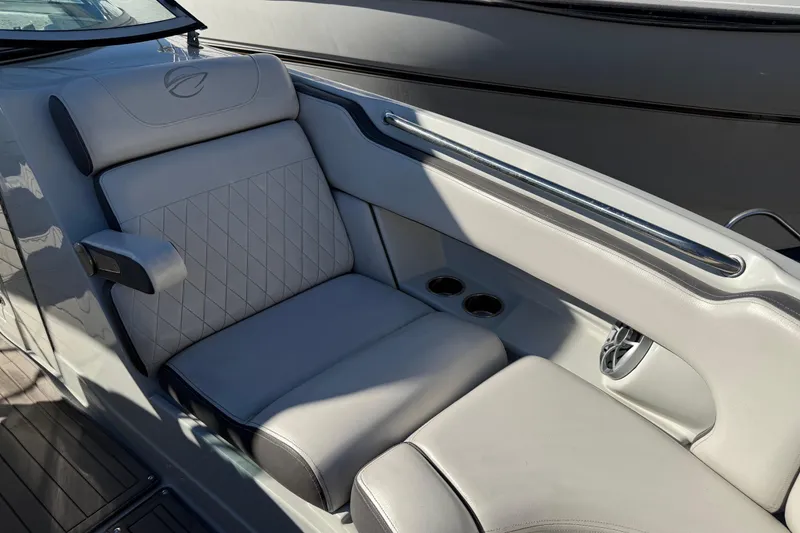 Slide: The Image of Luxurious seating on 2019 Crownline Eclipse E255 XS boat with cup holders and speaker. - 38
