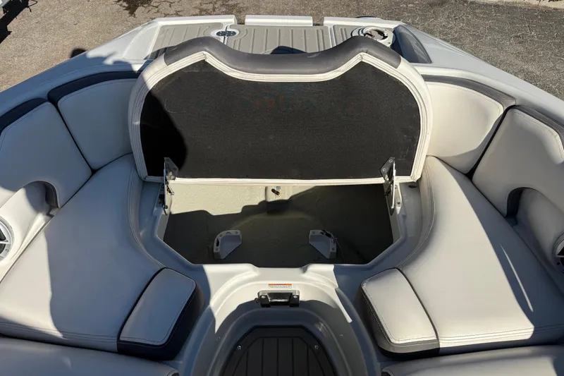 Slide: The Image of 2019 Crownline Eclipse E255 XS boat with open storage compartment and cushioned seating. - 39